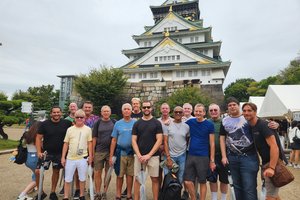 Group poses in front of Japanese temple