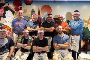 Group poses at a ramen cooking class